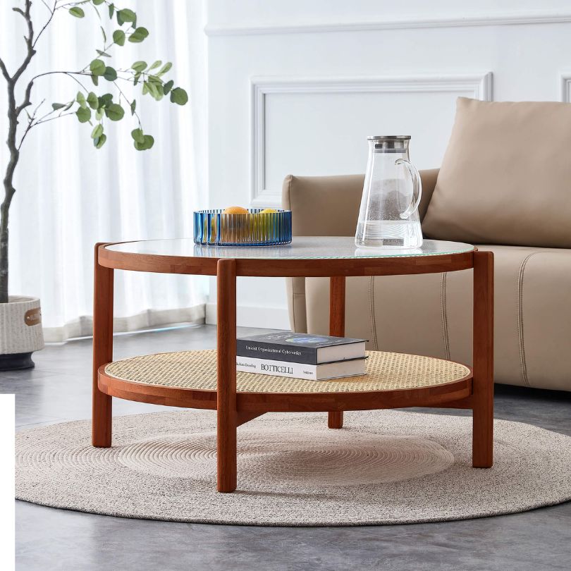 Close-up view of the rattan layer on the circular teak and glass coffee table.