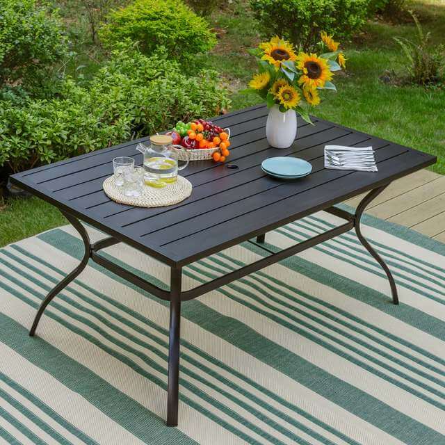 The table in a backyard setting, showcasing its elegant design and ample space for dining.