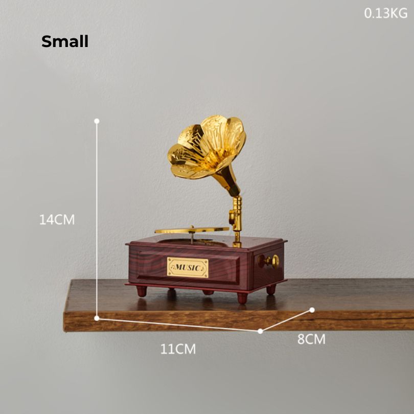 Phonograph music box figurine displayed on a shelf, enhancing the overall aesthetic of the living space.