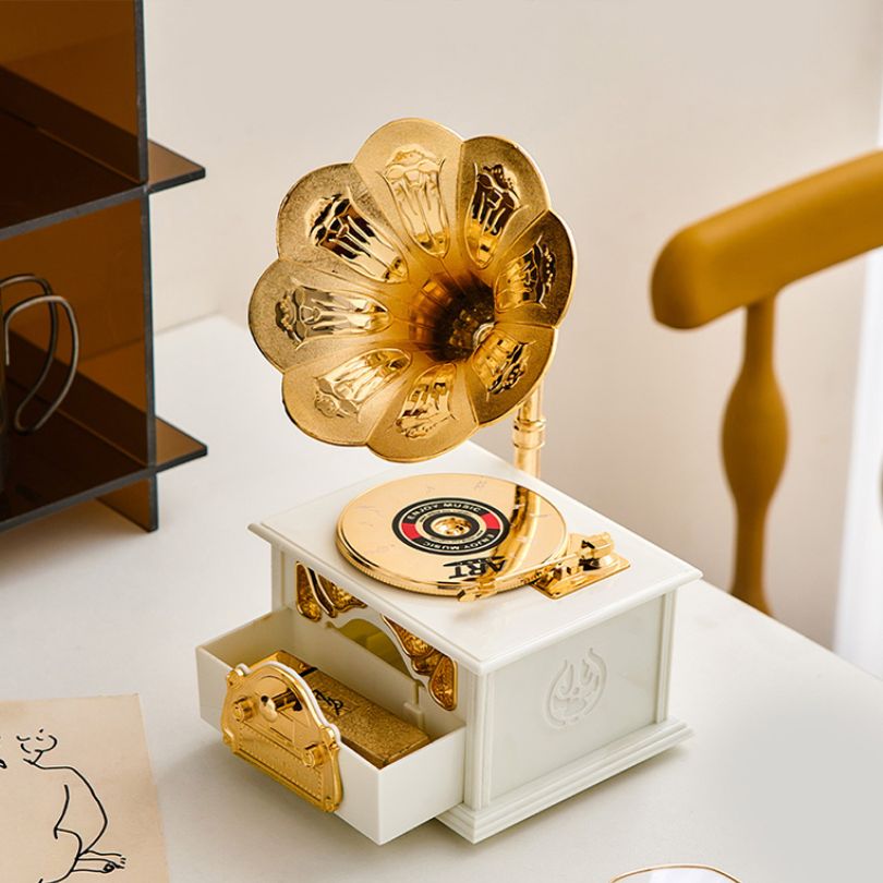 Vintage phonograph music box figurine showcasing intricate details and craftsmanship, perfect for home decoration.