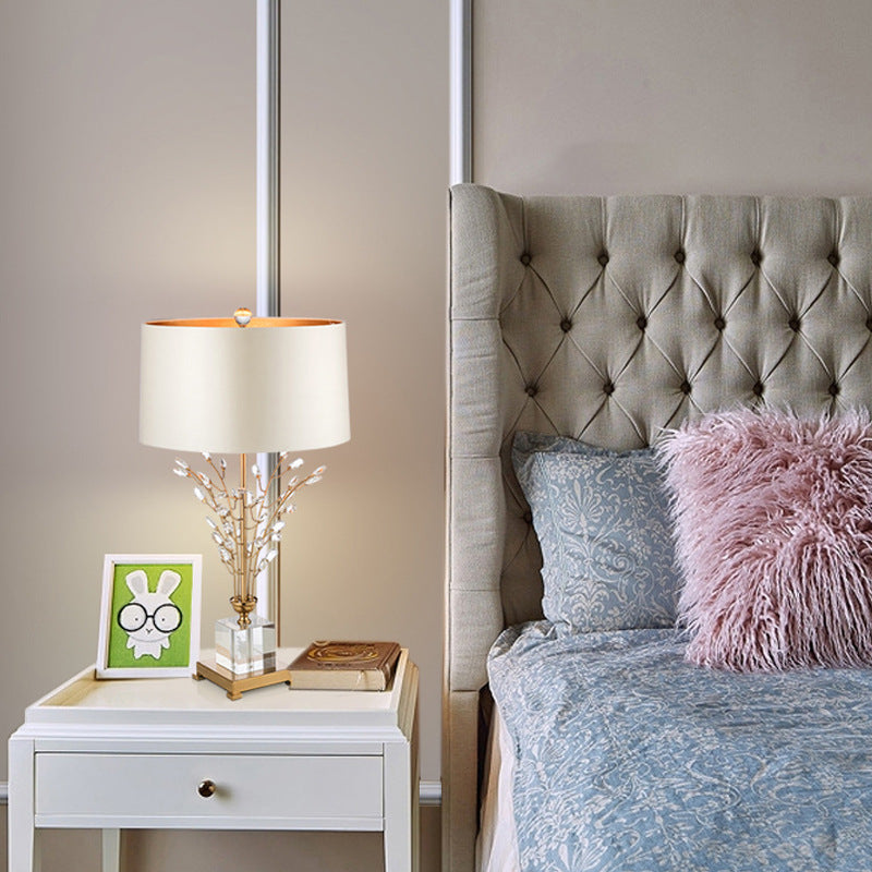 Luxury branched crystal table lamp with fabric shade in a living room setting, showcasing its modern style and elegant design.