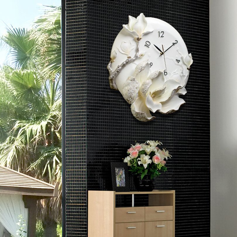 Close-up view of the orchid flower wall clock highlighting gold accents