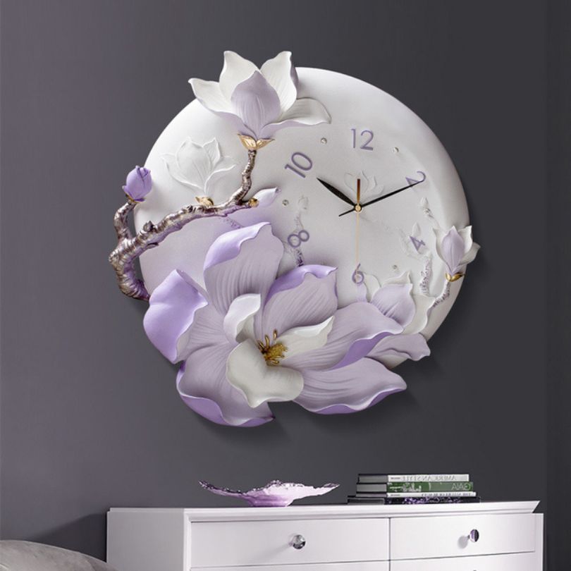 Close-up view of the orchid flower wall clock highlighting gold accents