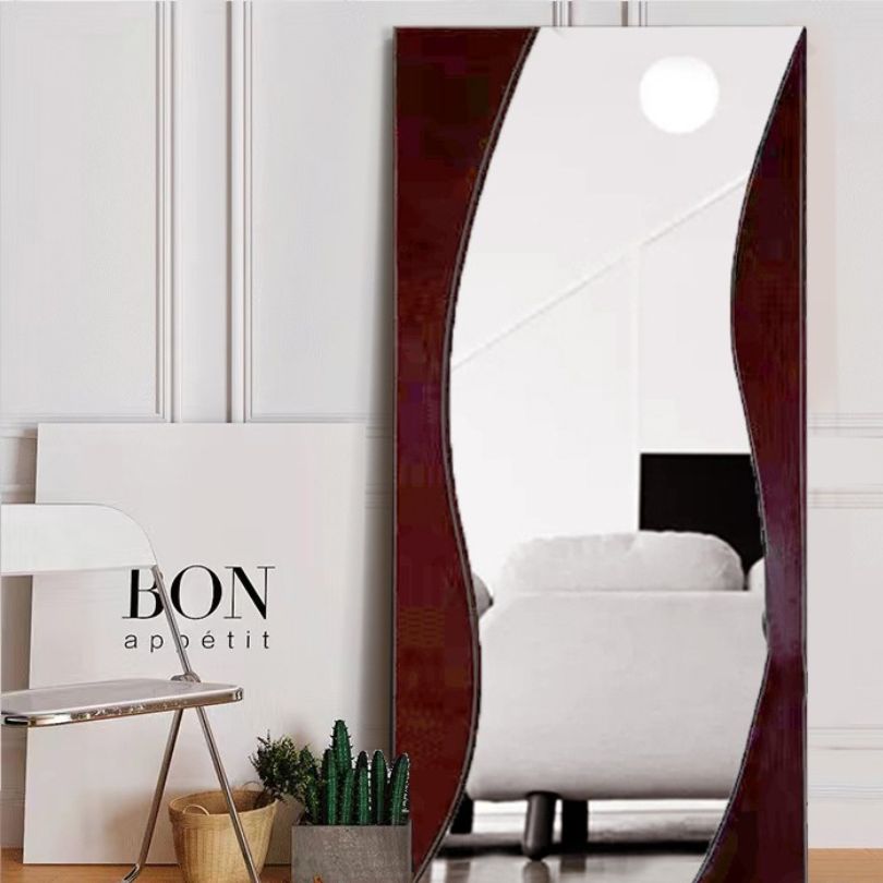 Standing mirror placed in a beautifully decorated bedroom, adding a touch of sophistication to the space.