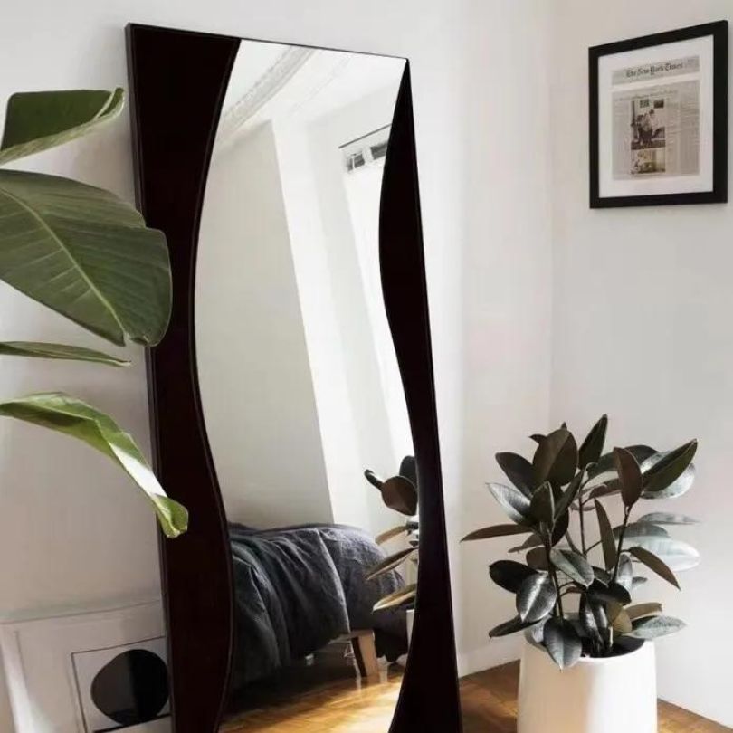 Side angle of the standing mirror highlighting its slim profile and shatterproof glass.