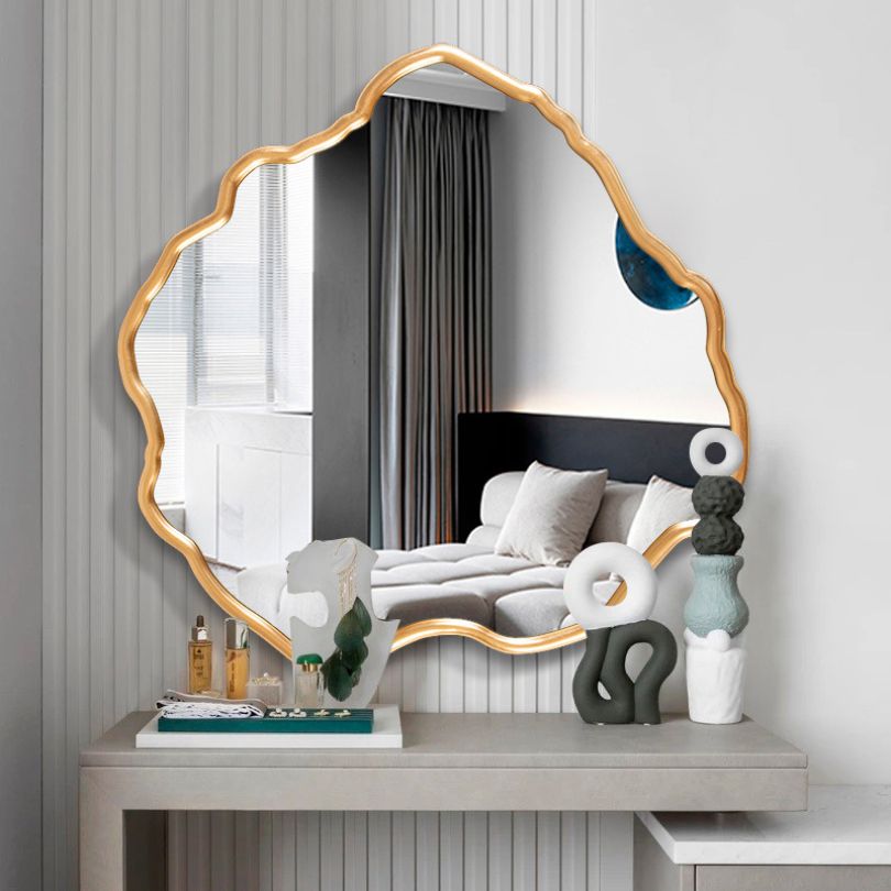 Stunning Gold Asymmetrical Vanity Wall Mirror hanging in a stylish hallway, reflecting natural light.