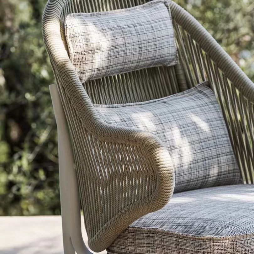 High-quality outdoor chair and footstool set positioned on a balcony.