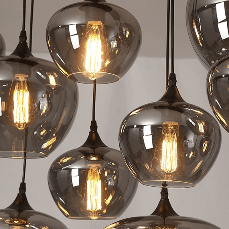 Modern smoked glass bubble pendant lights hanging in a stylish dining room.