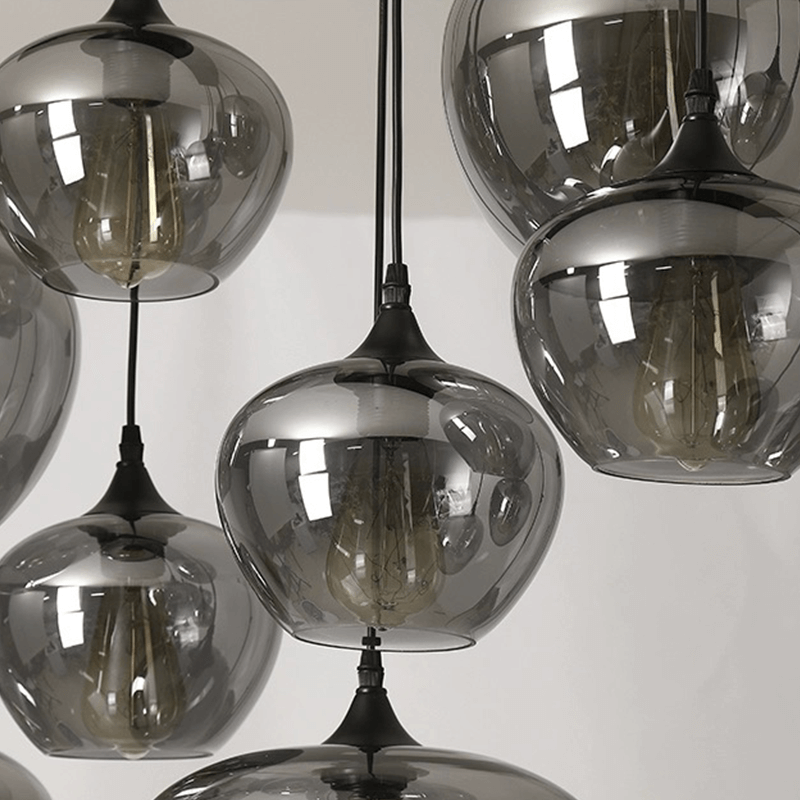 Adjustable smoked glass hanging lights illuminating a contemporary cafe.