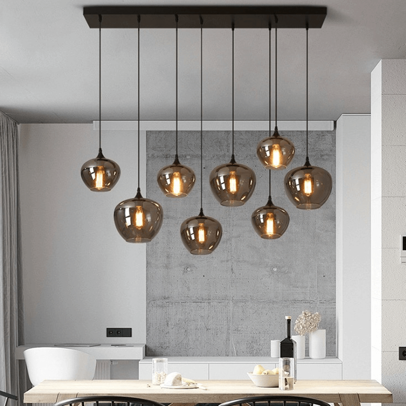 Adjustable smoked glass hanging lights illuminating a contemporary cafe.
