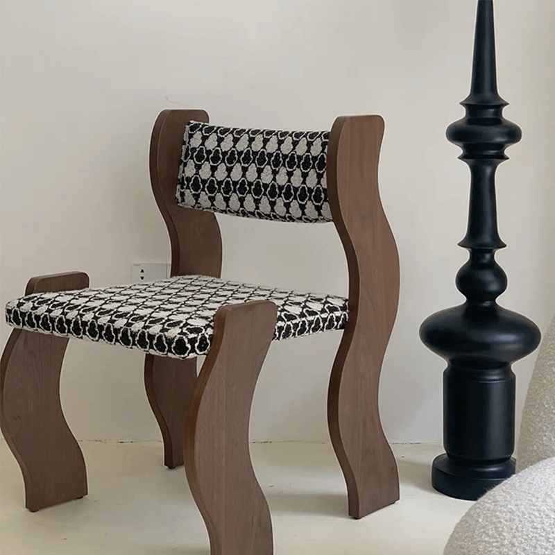 Close-up of the solid wood frame and plush cushion of the dining chair.