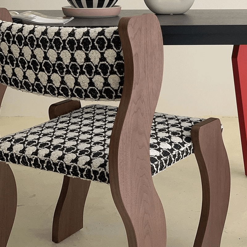 Wavy frame dining chair in black, showcasing its elegant design.