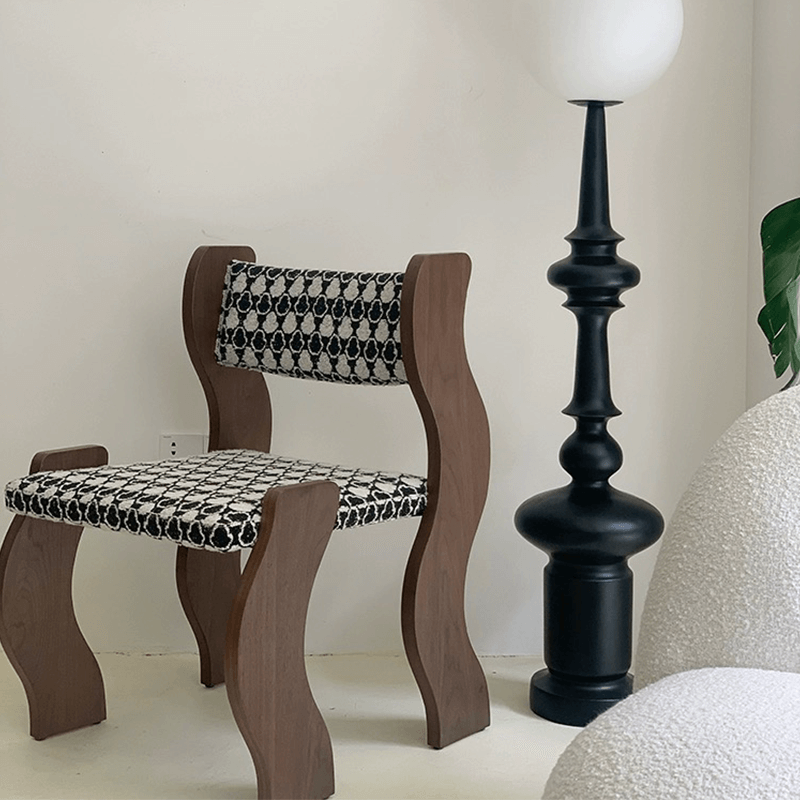 Wavy frame dining chair in black, showcasing its elegant design.