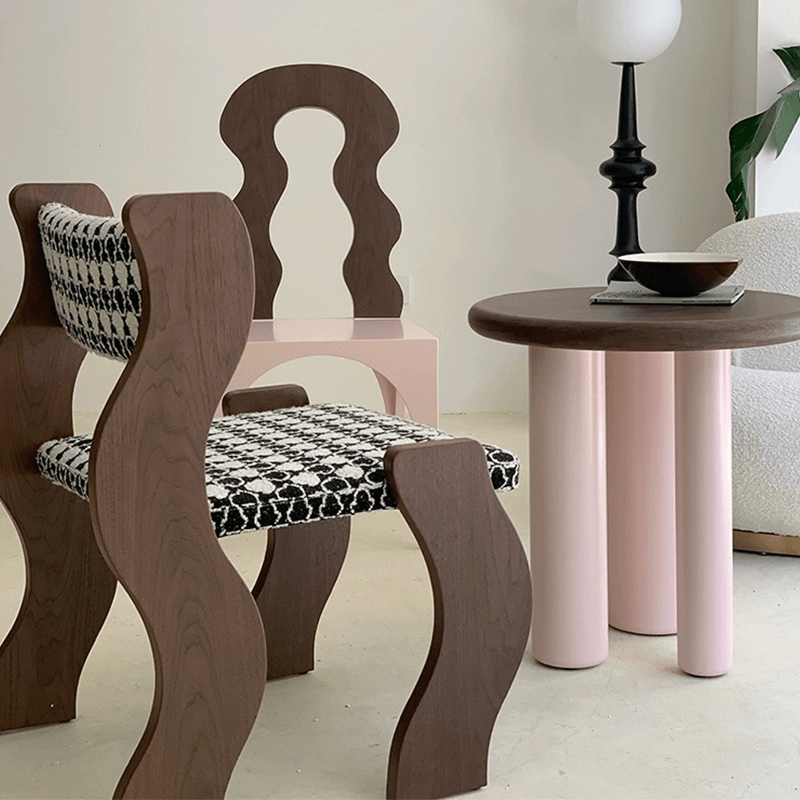 Stylish wavy frame dining chair with cushion in a modern dining room setting.