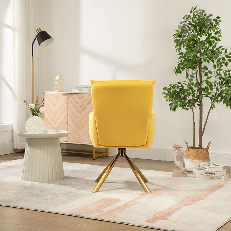 Close-up of the chic yellow velvet swivel accent chair, focusing on the luxurious fabric and gold legs.