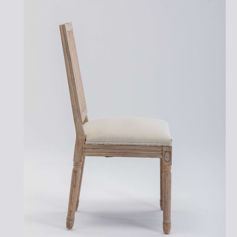 Angled view of Breeza high back chair showing beige upholstery and rattan detailing