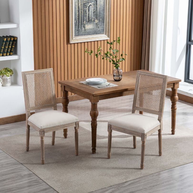 Angled view of Breeza high back chair showing beige upholstery and rattan detailing