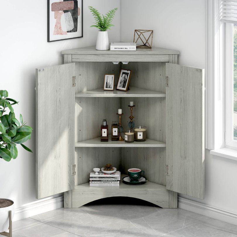 Corner oak bathroom cabinet showcasing adjustable shelves and elegant design from a front angle.