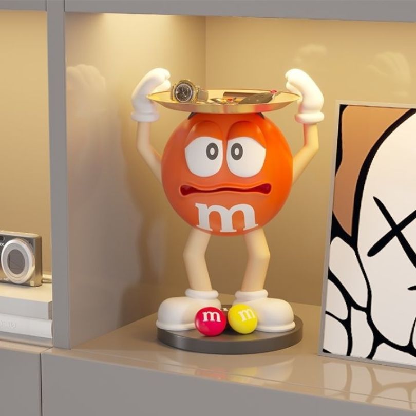 Front view of the vibrant resin bean statue with storage tray, showcasing its unique shape and color.