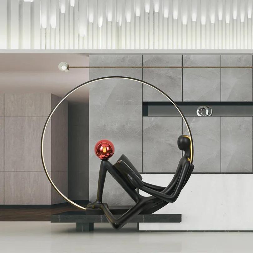 Side angle of the creative floor sculpture highlighting its round shape and LED light source.