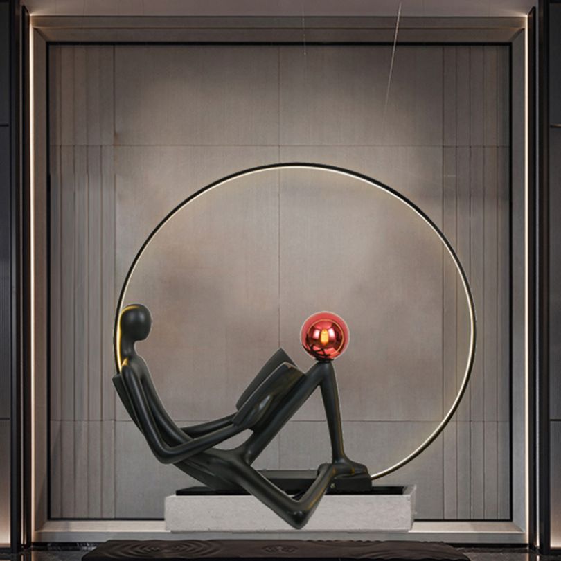 Close-up view of the black illuminated floor sculpture showcasing its unique postmodern design.