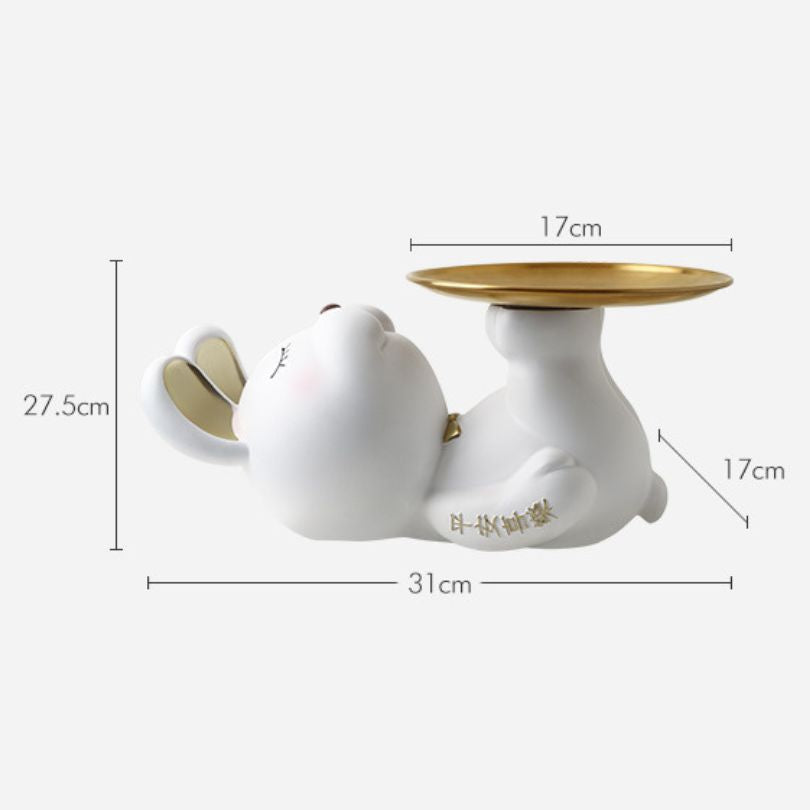 Elegant rabbit sculpture key storage displayed on a shelf with decorative items.