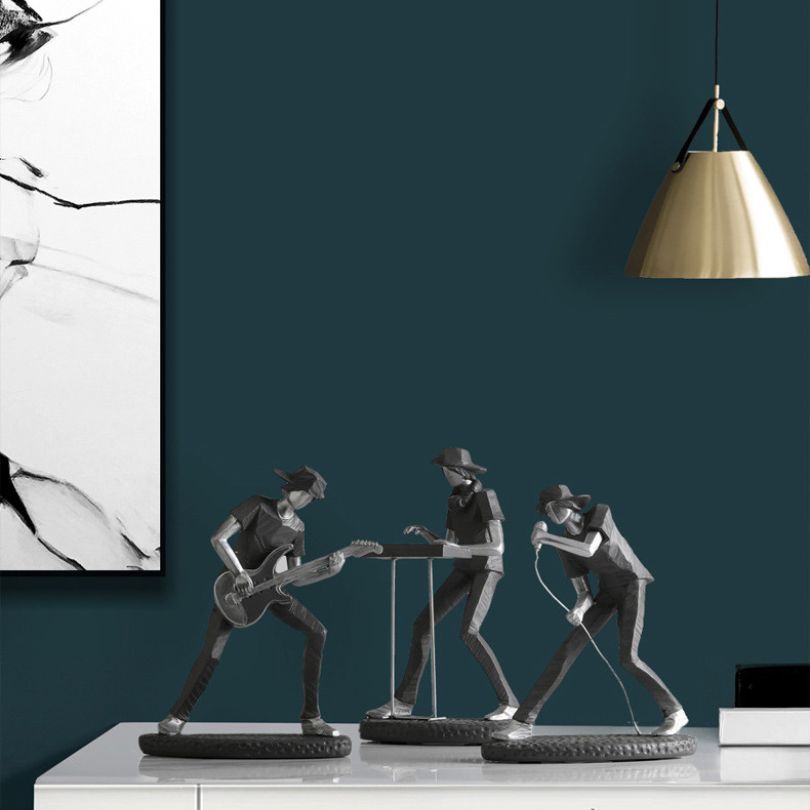 Rock band figurine on a desk, showcasing vibrant musicians.