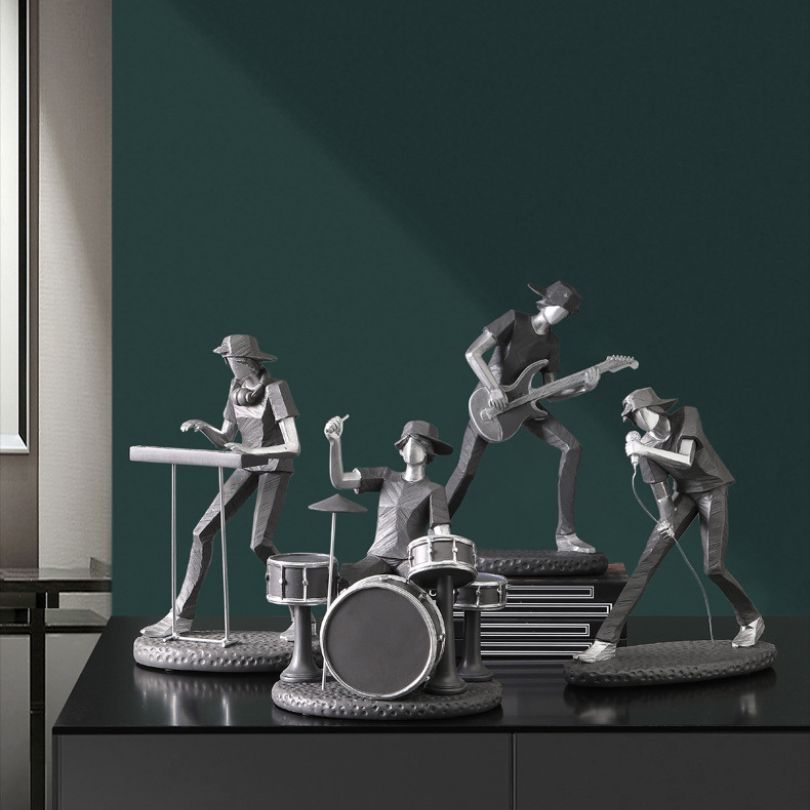 Rock band figurine on a desk, showcasing vibrant musicians.