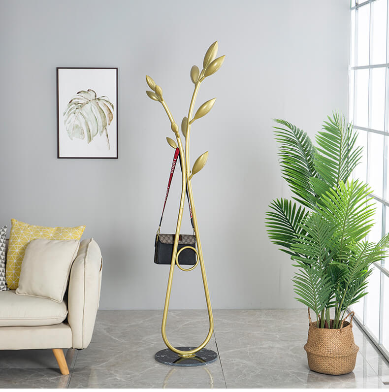 Close-up view of the tree branch hanger highlighting its elegant gold finish and multiple hooks for convenience.