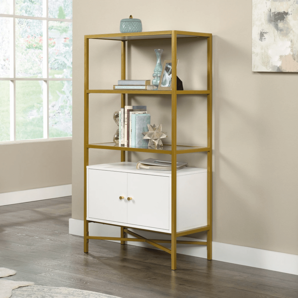 Curiod Luxe Gold Metal Bookcase showcasing books and decor items on glass shelves
