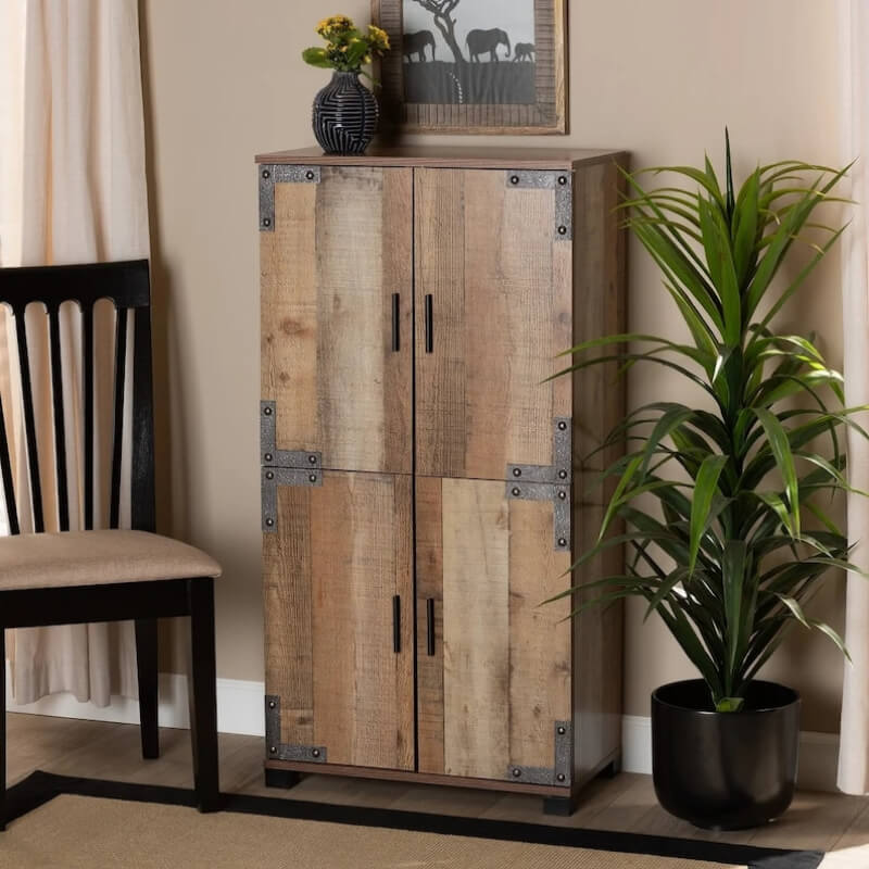 Front view of rustic furniture shoe cabinet with oak finish and metal details in a small entryway setting