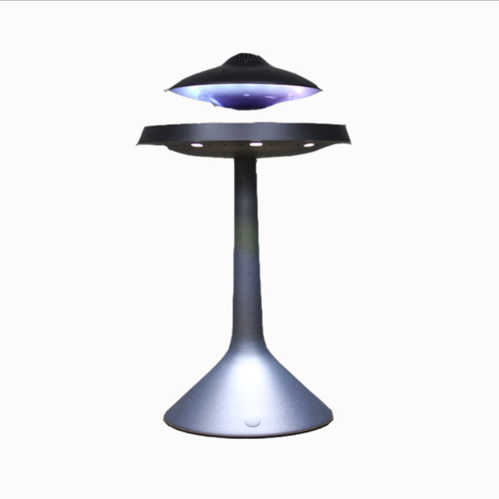 The UFO 3D smart table lamp in a cozy bedroom setting, creating a warm ambiance.