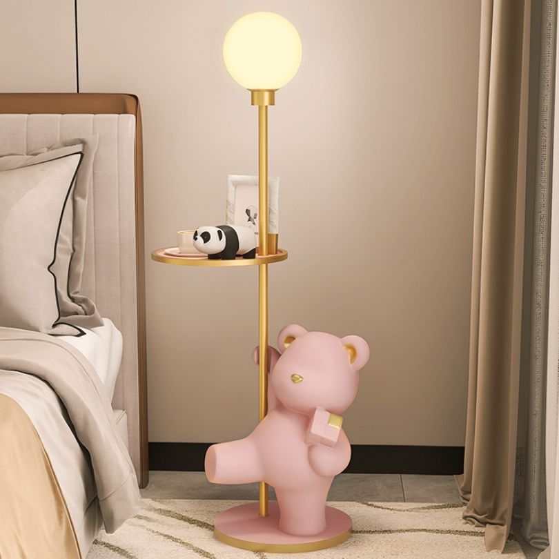 Bear statue lamp on a shelf with decorative items
