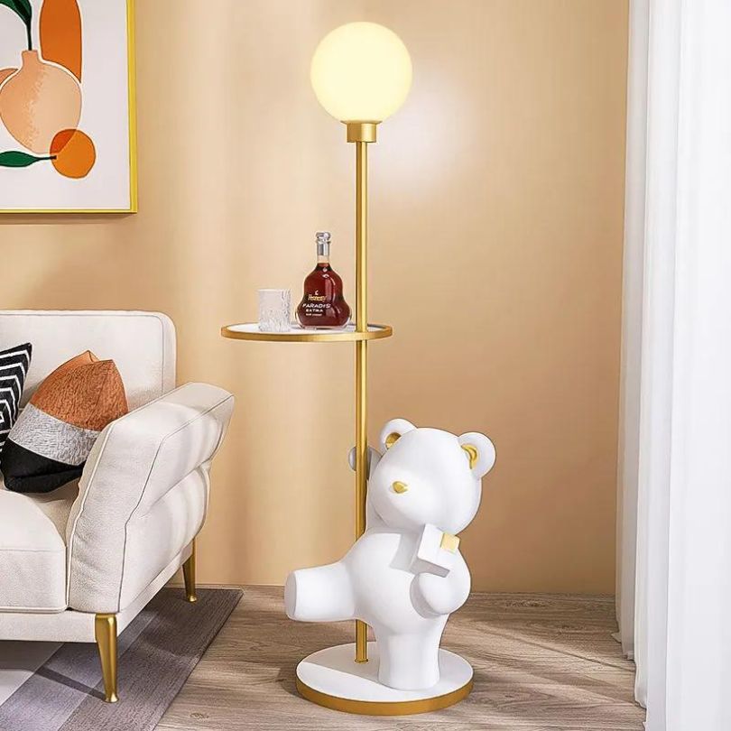 Bear statue lamp on a shelf with decorative items