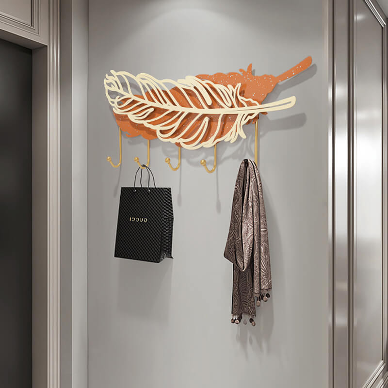 Elegant Feather Wall Hook Rack in a modern entryway, holding coats and scarves.