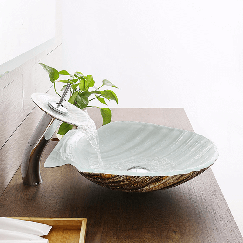 Close-up view of the decorative scallop sink featuring a copper faucet and tempered glass.