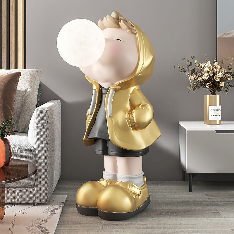 The colorful cartoon boy statue placed in a childrens room, enhancing the playful atmosphere.