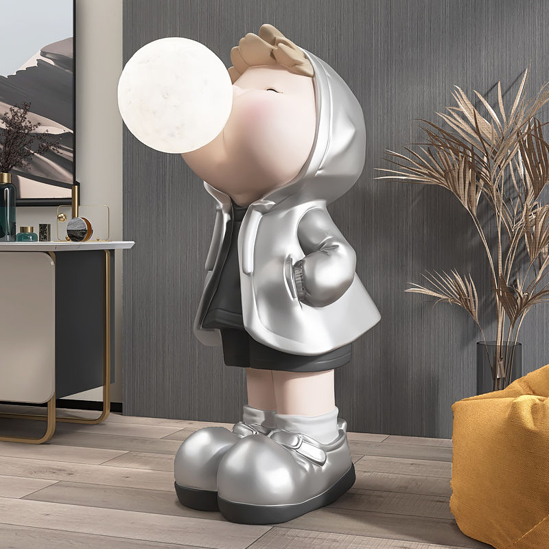 Colorful cartoon boy statue displayed on a shelf, adding charm to home decor.