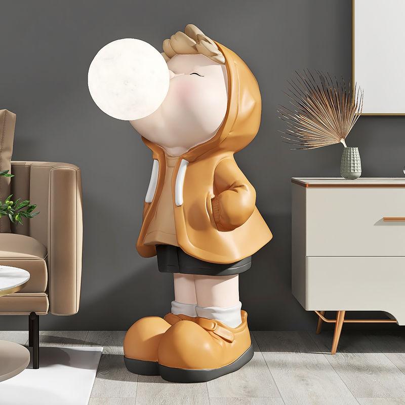 Colorful cartoon boy statue displayed on a shelf, adding charm to home decor.