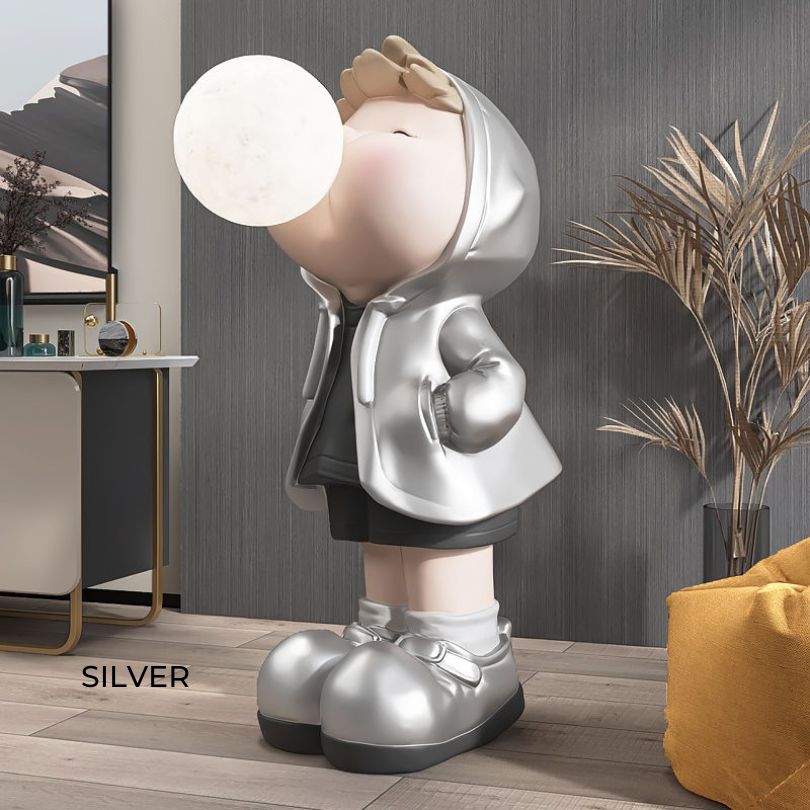 Colorful cartoon boy statue displayed on a shelf, adding charm to home decor.
