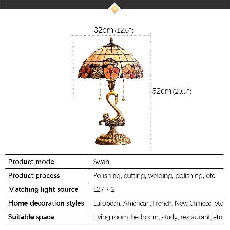 Close-up of the swan brass lamp highlighting the clear glass shade and intricate details.