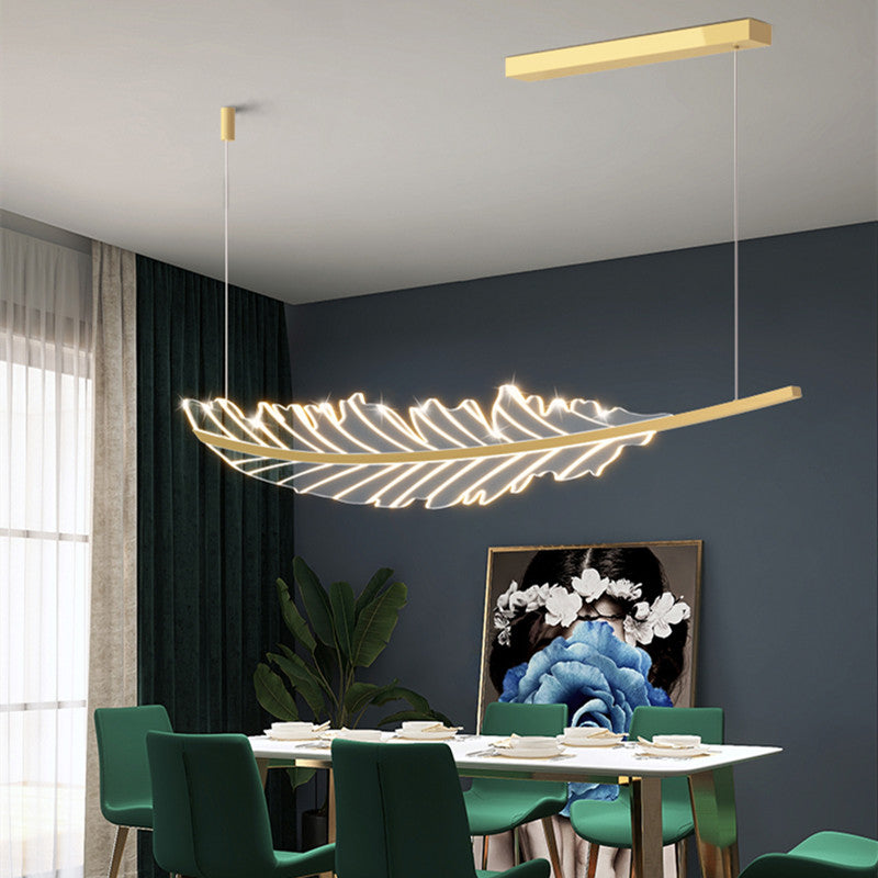 Close-up view of the gold leaf pendant lamp, highlighting the brushed gold finish and LED lights.