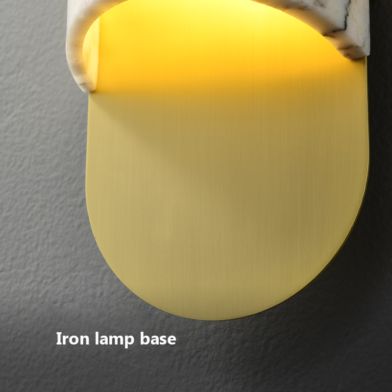 The Elegant Copper Marble LED Wall Sconce illuminating a cozy study area.
