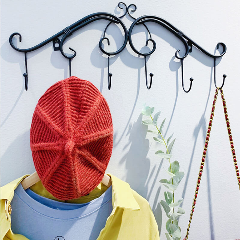 Close-up of wall-mounted storage hooks showing sturdy metal craftsmanship and retro style