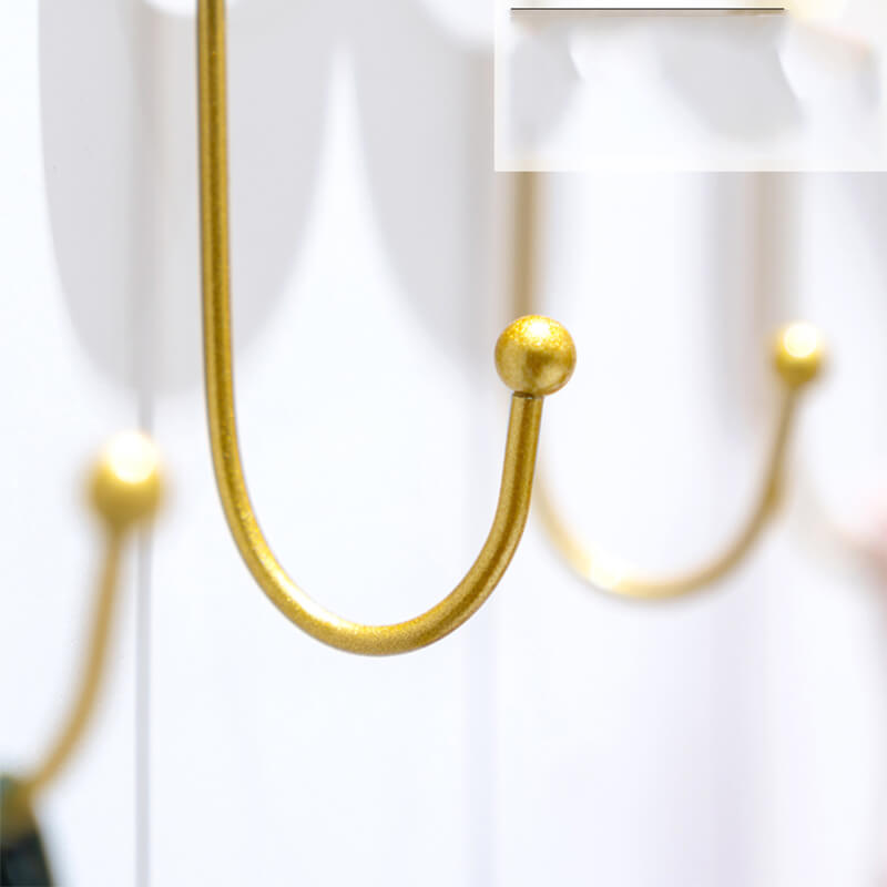 Close-up of wall-mounted storage hooks showing sturdy metal craftsmanship and retro style