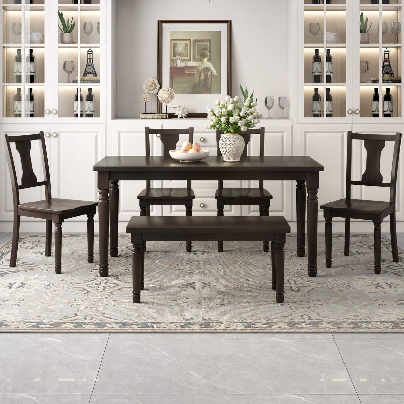 Espresso dining table set with bench and chairs in a rustic dining room