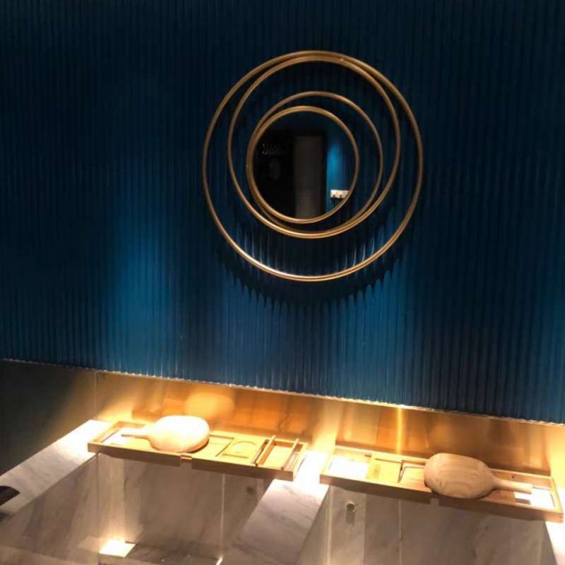 The gold mirror displayed above a bathroom vanity, adding elegance and depth to the space.