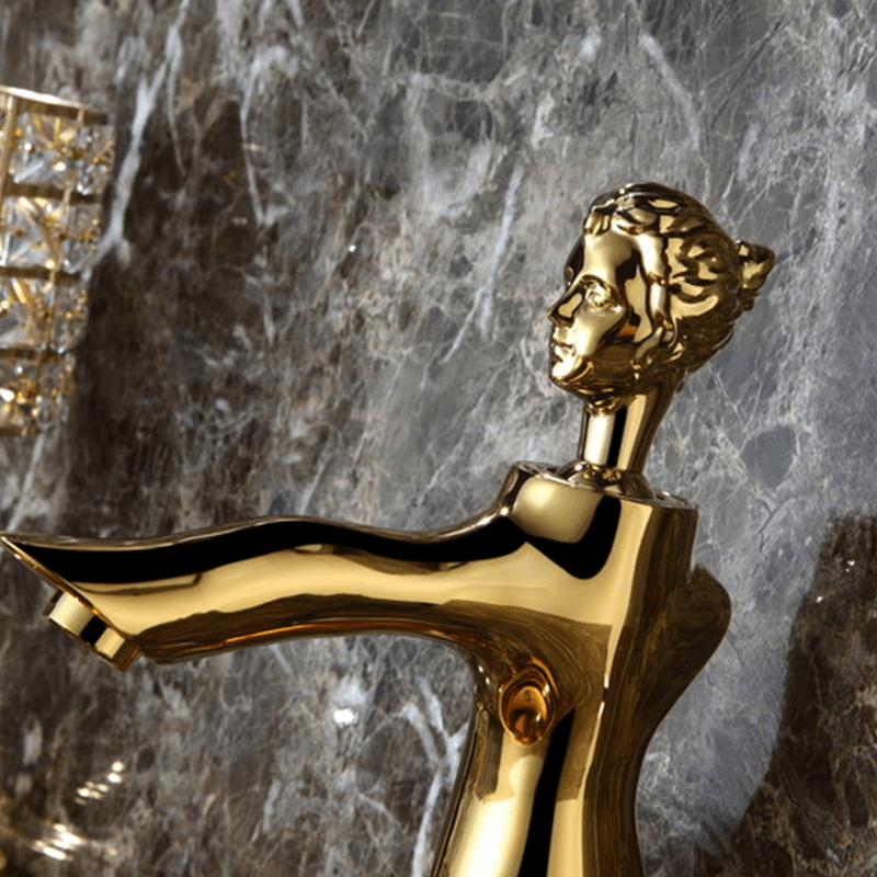 Close-up of the gold faucets handle, demonstrating its smooth operation and artistic details.