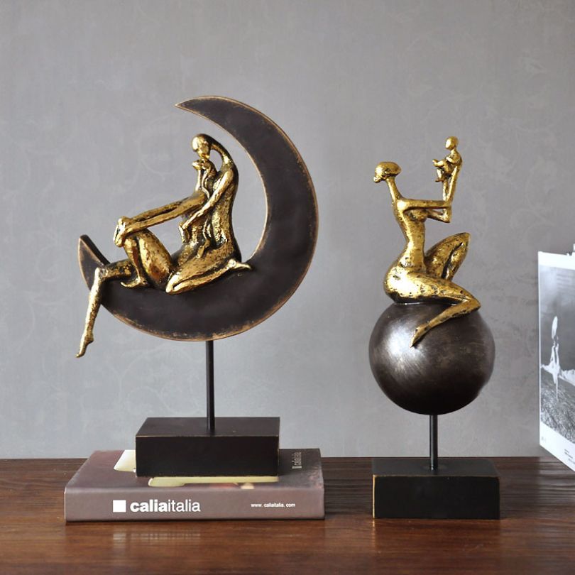 Side angle of the mother and child art piece, emphasizing its unique shape and design.