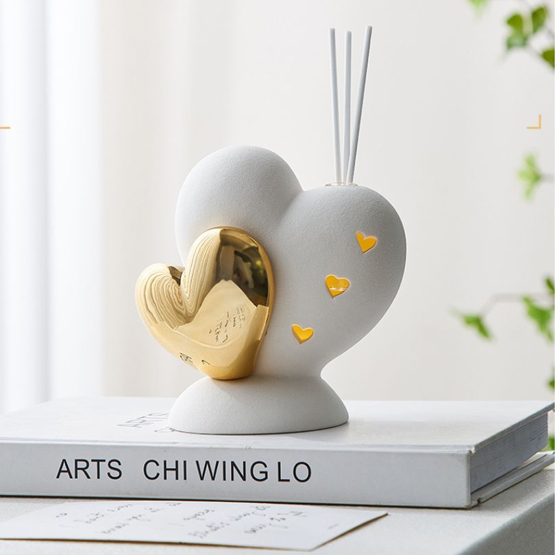 Ceramic love shape ornament displayed on a shelf, enhancing the rooms love decor theme.